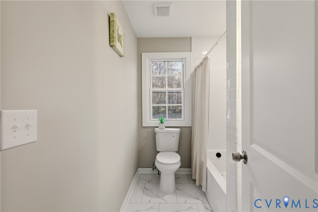 6280 Monahan Road Henrico, VA 23231 - Photo 32 of 42 a white toilet sitting next to a bathroom sink