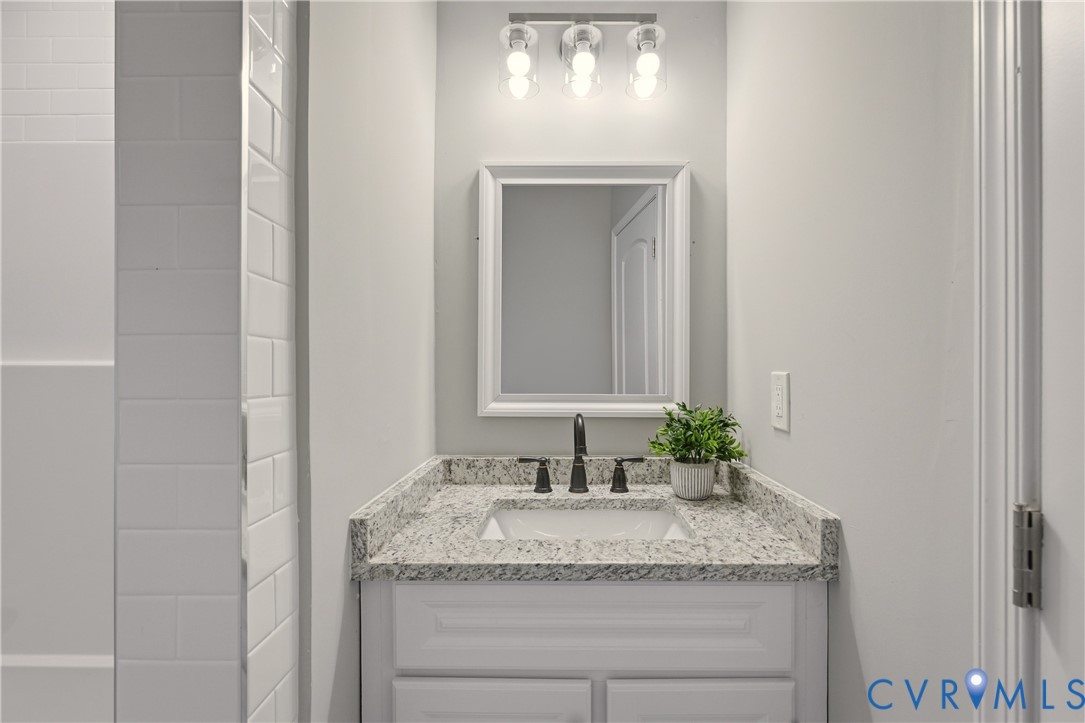 6280 Monahan Road Henrico, VA 23231 - Photo 33 of 42 a bathroom with a granite countertop sink and a mirror