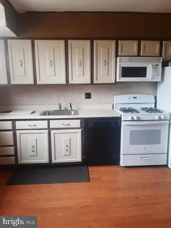 a kitchen with stainless steel appliances a stove microwave and cabinets