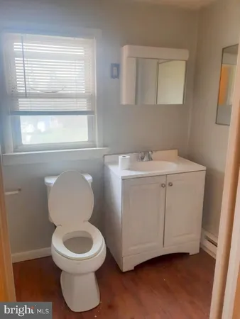 a bathroom with a toilet sink and mirror