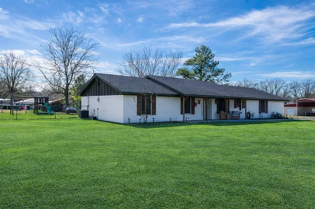 a backyard of a house with a garden and deck