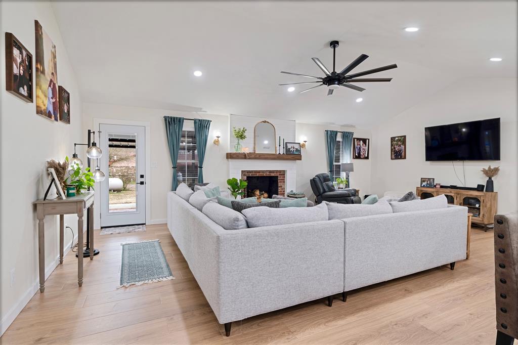 19 43040th Powderly, TX 75473 - Photo 8 of 21 a living room with furniture a fireplace and a flat screen tv