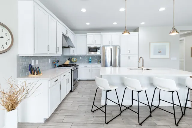 a bathroom with a granite countertop sink toilet mirror and bathtub