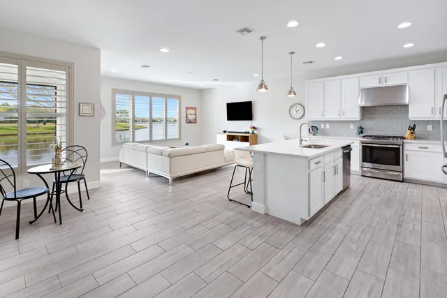 a living room with furniture large window and flat screen tv