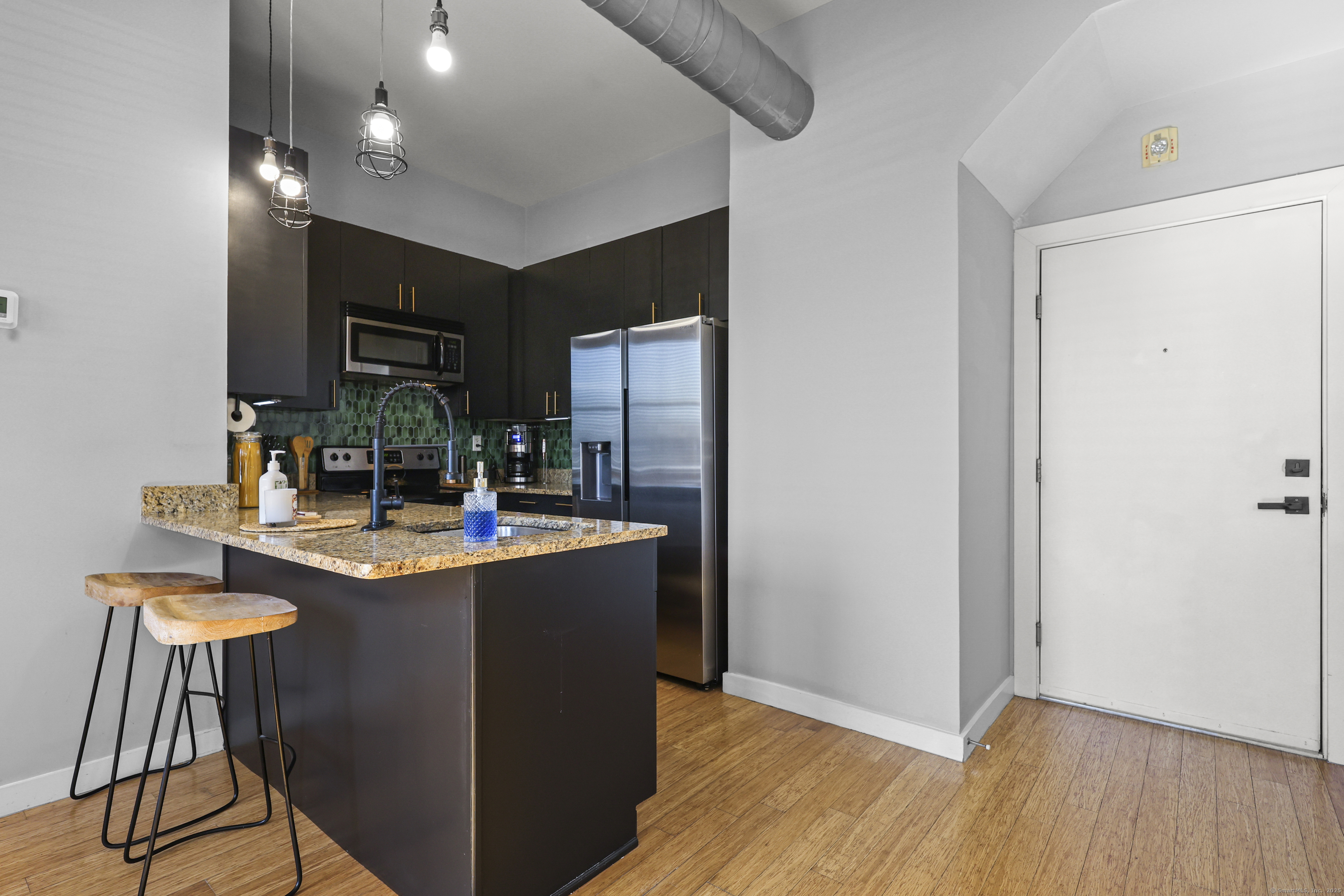 881 Lafayette Boulevard, Unit 1A Bridgeport, CT 06604 - Photo 13 of 37 a kitchen with kitchen island stainless steel appliances a sink stove and refrigerator