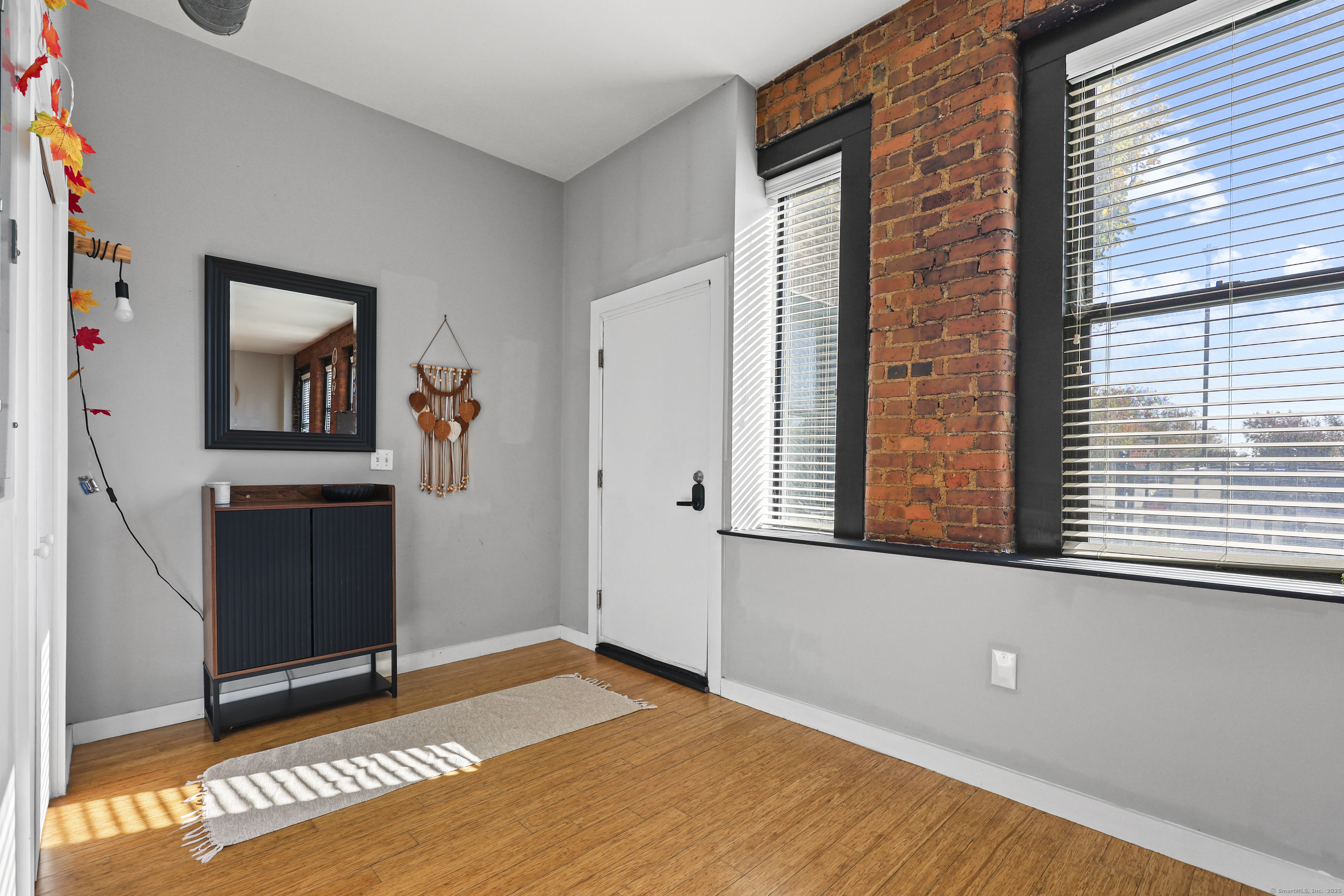881 Lafayette Boulevard, Unit 1A Bridgeport, CT 06604 - Photo 16 of 37 a view of an empty room with window and hardwood floor