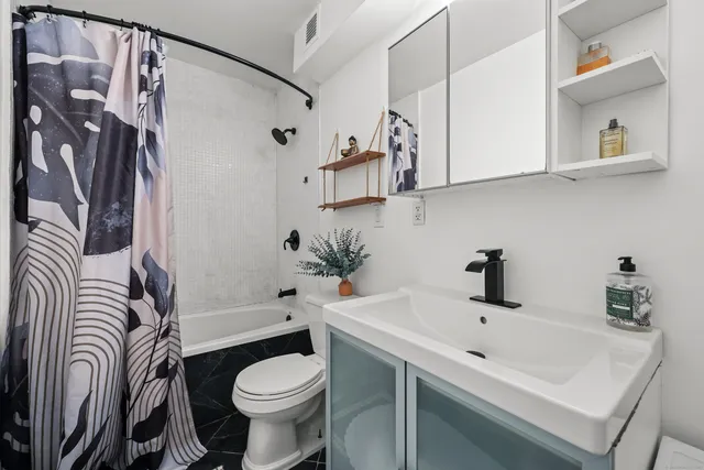 a bathroom with a sink toilet and shower