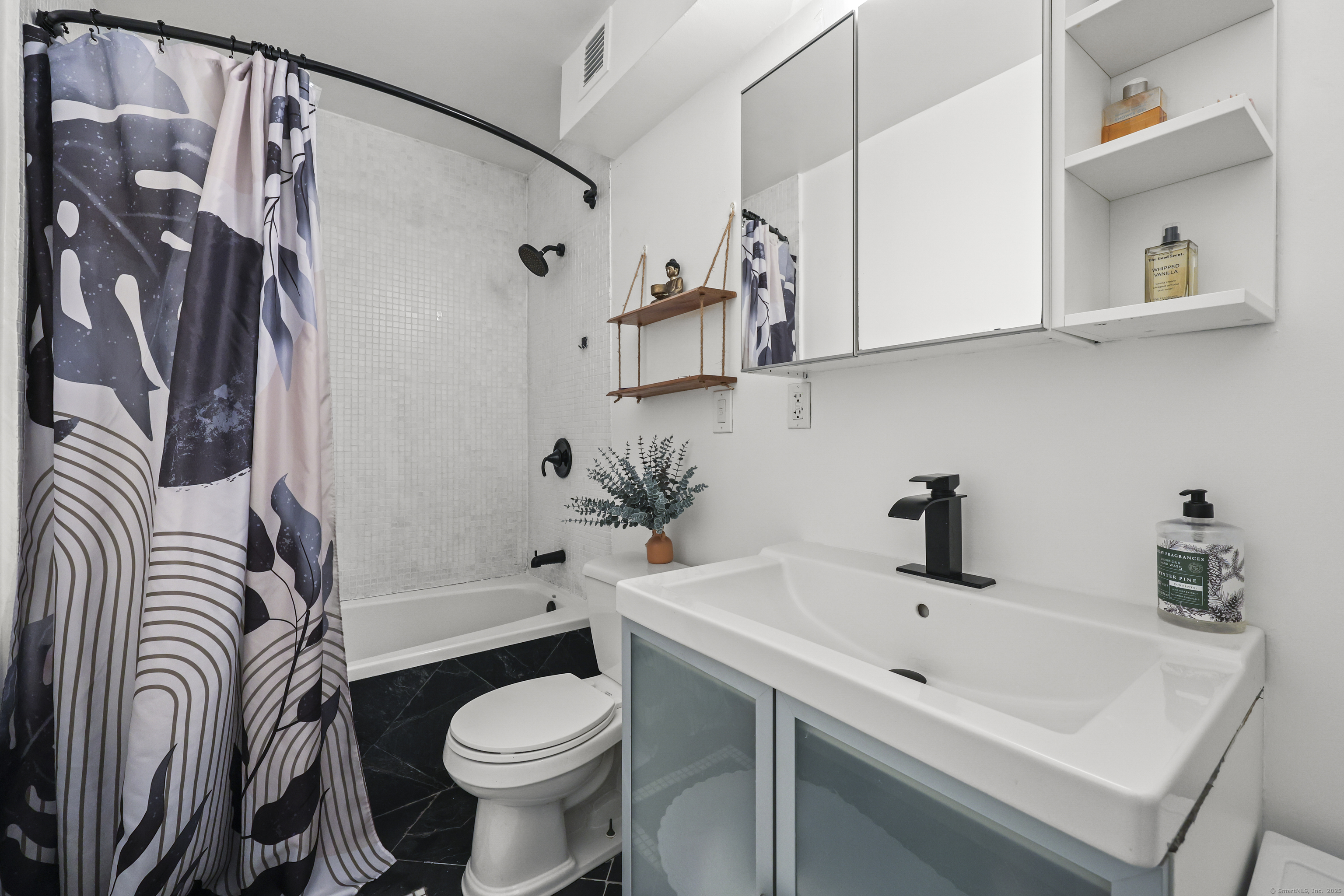 881 Lafayette Boulevard, Unit 1A Bridgeport, CT 06604 - Photo 17 of 37 a bathroom with a sink toilet and shower