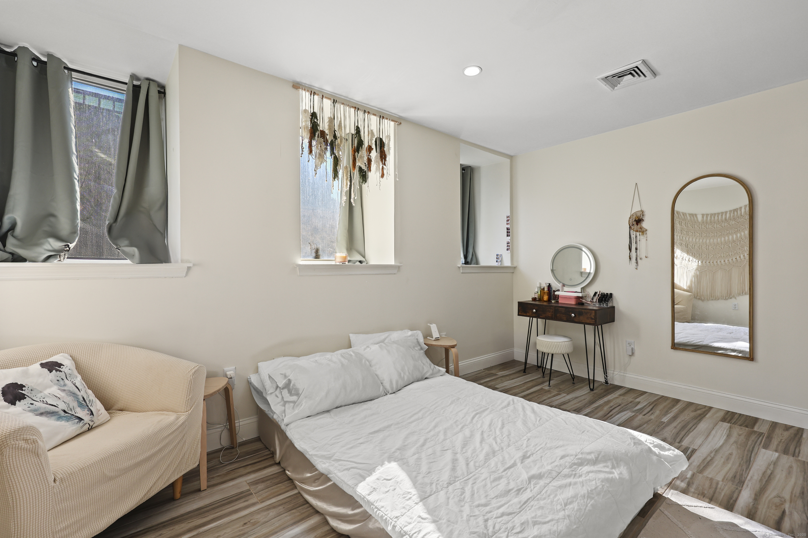 881 Lafayette Boulevard, Unit 1A Bridgeport, CT 06604 - Photo 18 of 37 a bedroom with a bed and wooden floor