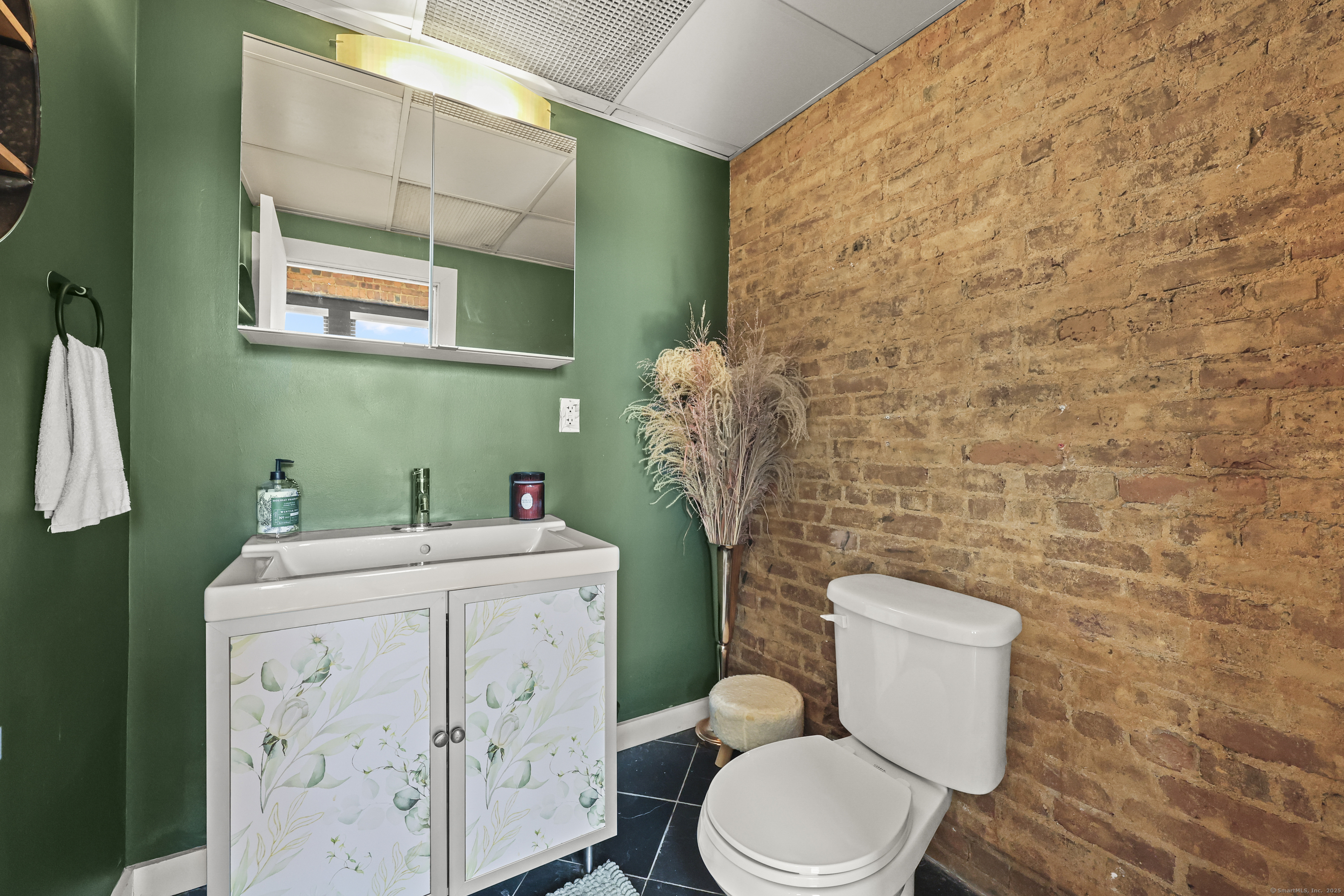 881 Lafayette Boulevard, Unit 1A Bridgeport, CT 06604 - Photo 21 of 37 a bathroom with a toilet sink and mirror