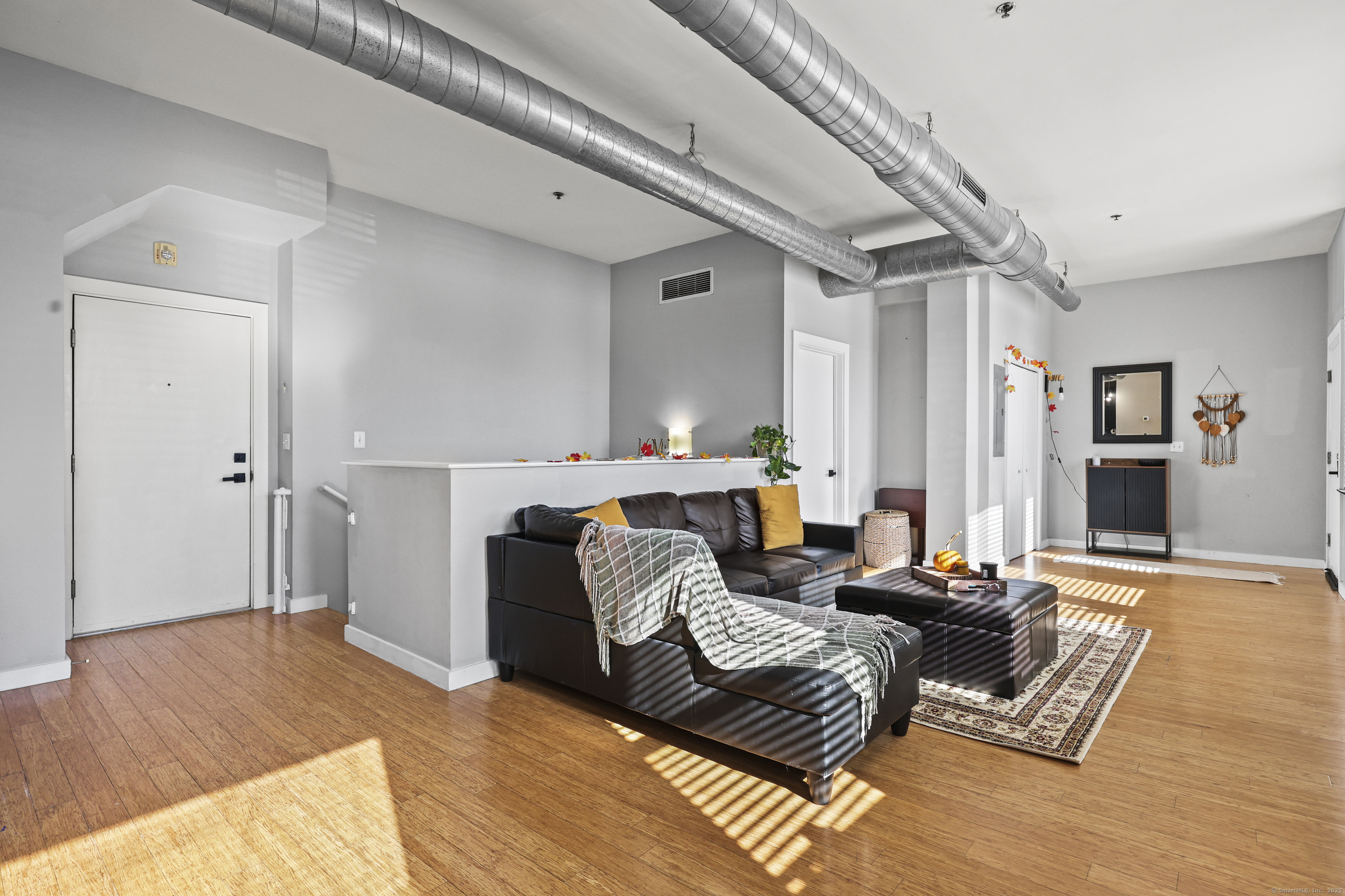 881 Lafayette Boulevard, Unit 1A Bridgeport, CT 06604 - Photo 22 of 37 a living room with furniture and a wooden floor