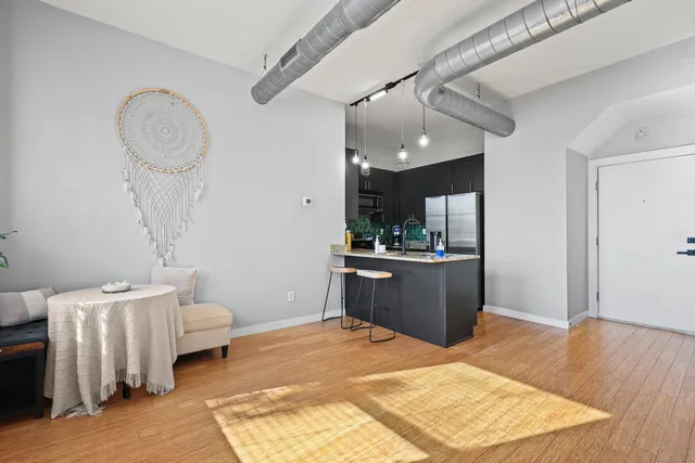 a living room with a couch and a chandelier