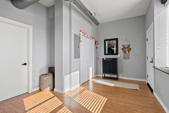 a view of a bedroom with wooden floor and bed