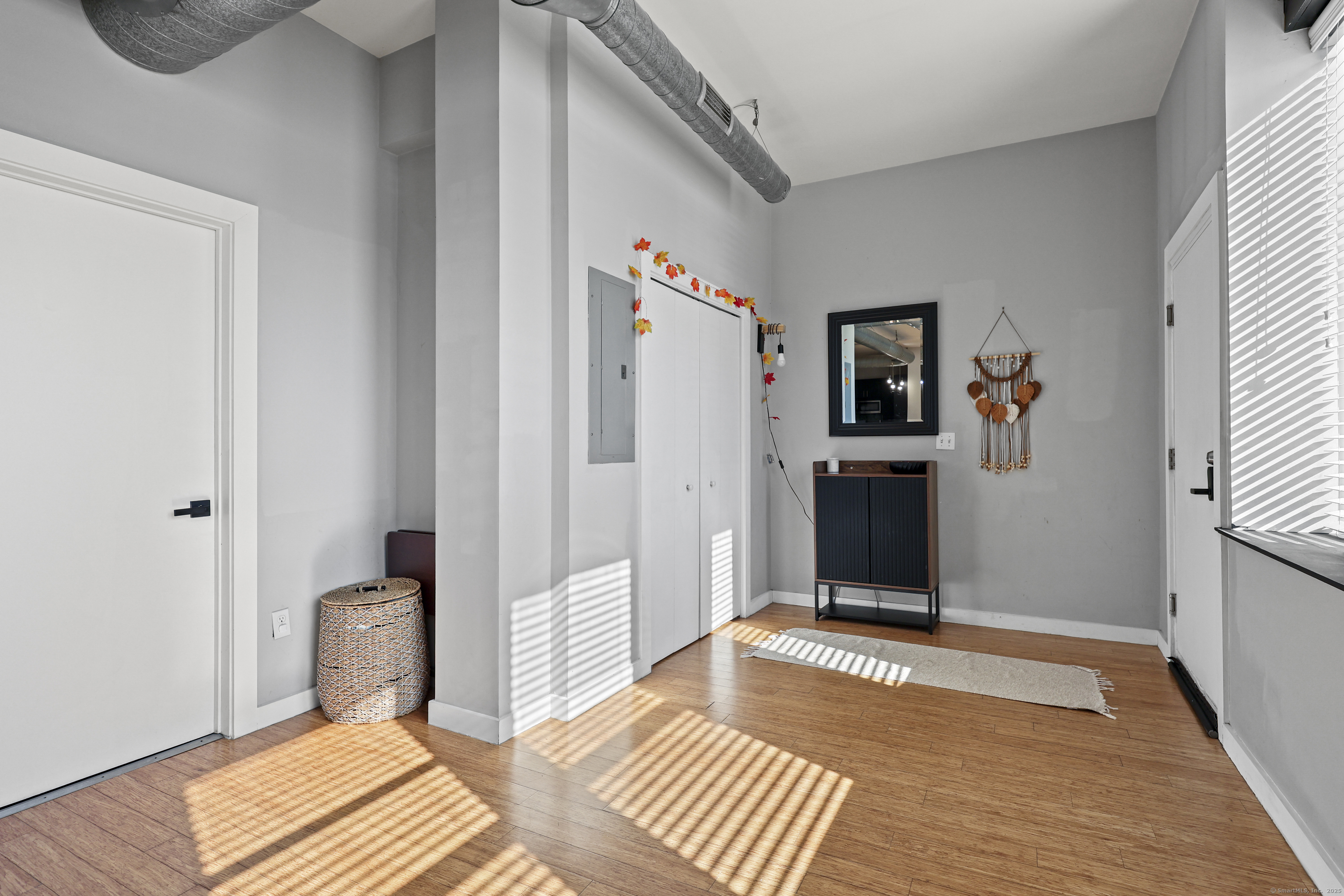 881 Lafayette Boulevard, Unit 1A Bridgeport, CT 06604 - Photo 25 of 37 a view of a bedroom with wooden floor and bed