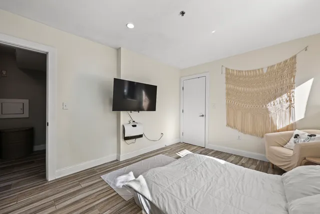 a bedroom with a bed and a flat screen tv