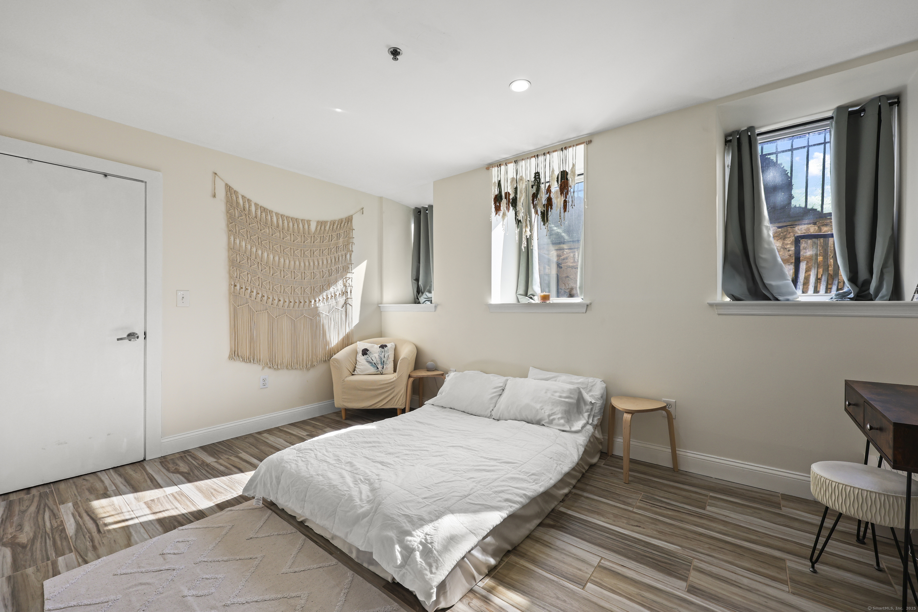 881 Lafayette Boulevard, Unit 1A Bridgeport, CT 06604 - Photo 27 of 37 a bedroom with a bed and wooden floor