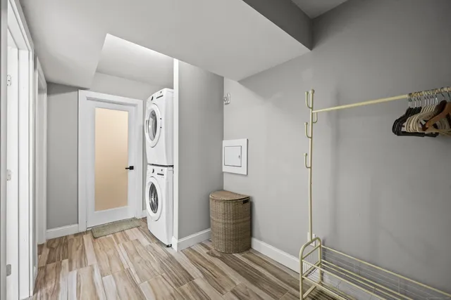 a view of a hallway with wooden floor and closet