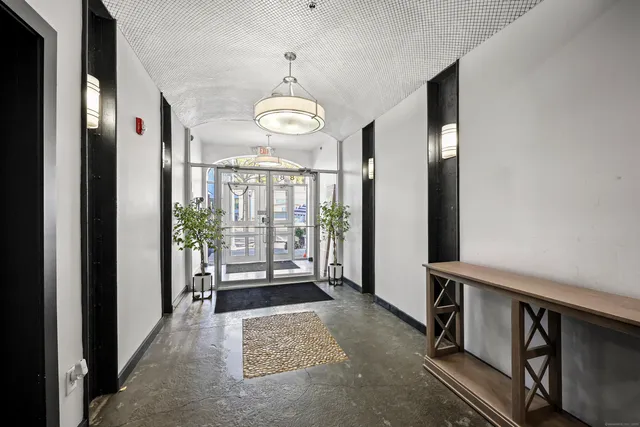 a view of a room with furniture wooden floor and chandelier