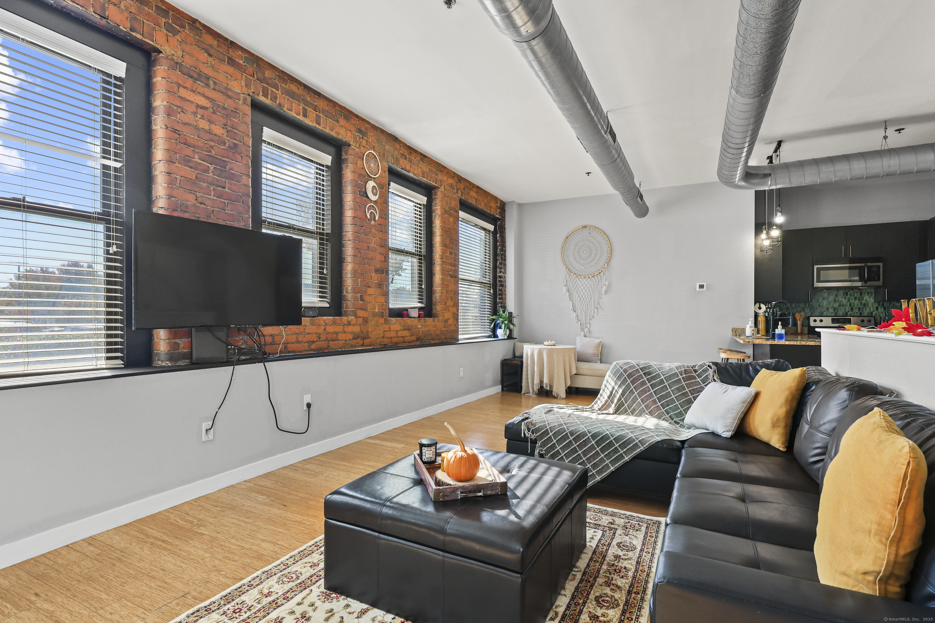 881 Lafayette Boulevard, Unit 1A Bridgeport, CT 06604 - Photo 9 of 37 a living room with furniture and a flat screen tv