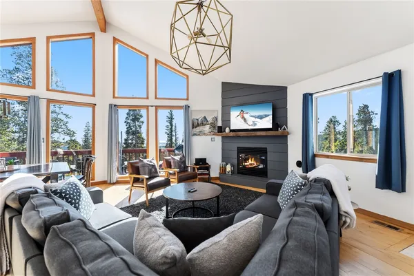 a living room with furniture a fireplace and a large window