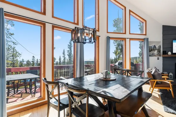 a view of a dining room with furniture large windows and wooden floor