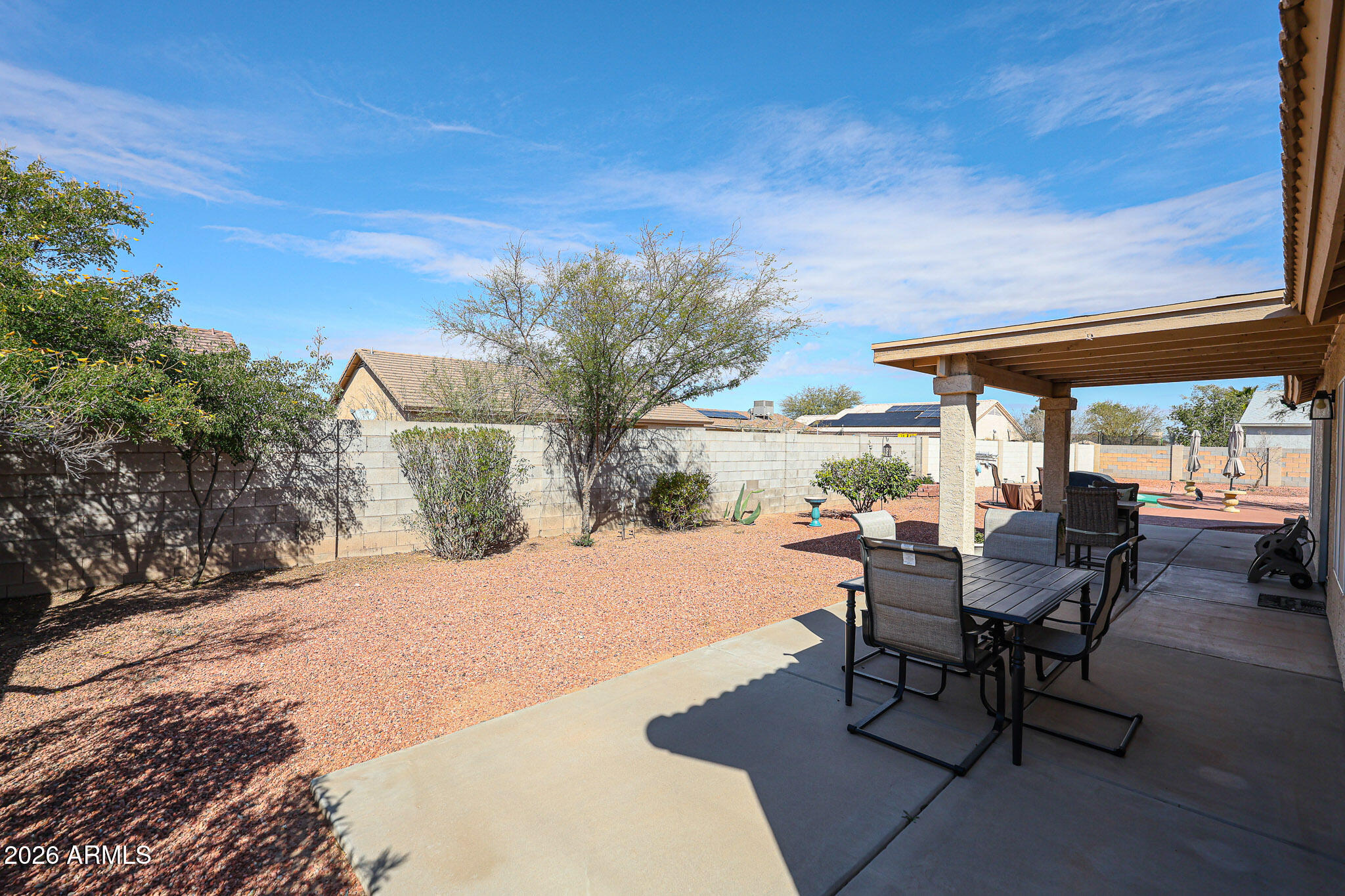 14980 South Capistrano Road Arizona City, AZ 85123 - Photo 34 of 39 a view of a backyard with table and chairs under an umbrella