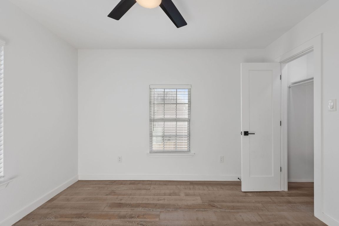 3004 Webberville Road, Unit 1 Austin, TX 78702 - Photo 10 of 12 an empty room with ceiling fan and window