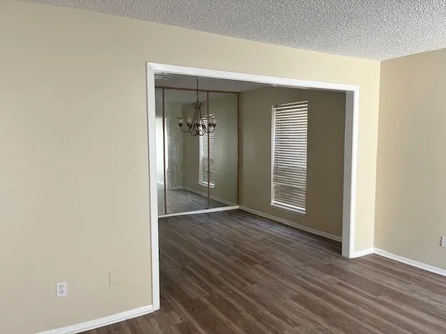 an empty room with wooden floor and closet