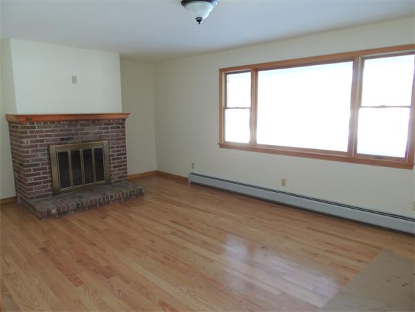 21 State Road Whately, MA 01373 - Photo 13 of 23 an empty room with wooden floor fireplace and windows