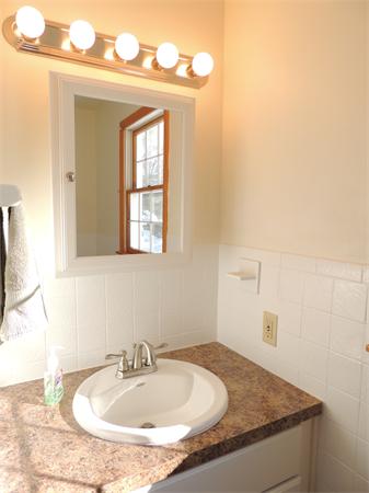 21 State Road Whately, MA 01373 - Photo 14 of 23 a bathroom with a granite countertop sink and a mirror