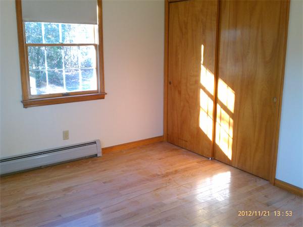21 State Road Whately, MA 01373 - Photo 8 of 23 an empty room with wooden floor and windows