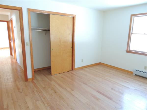 21 State Road Whately, MA 01373 - Photo 9 of 23 an empty room with wooden floor and a window