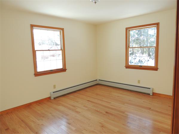 21 State Road Whately, MA 01373 - Photo 10 of 23 an empty room with wooden floor and windows