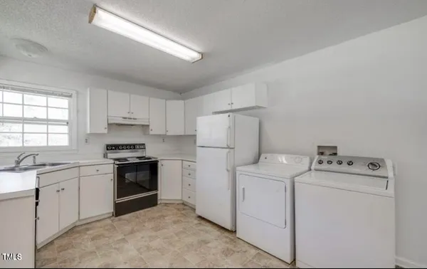 a kitchen with a sink stove and refrigerator