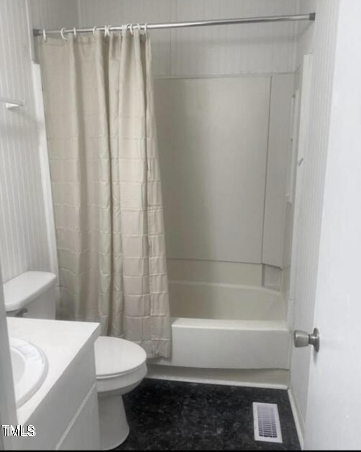 626 Maple Lane Raleigh, NC 27603 - Photo 7 of 8 a white bath tub sitting next to a white toilet and curtain