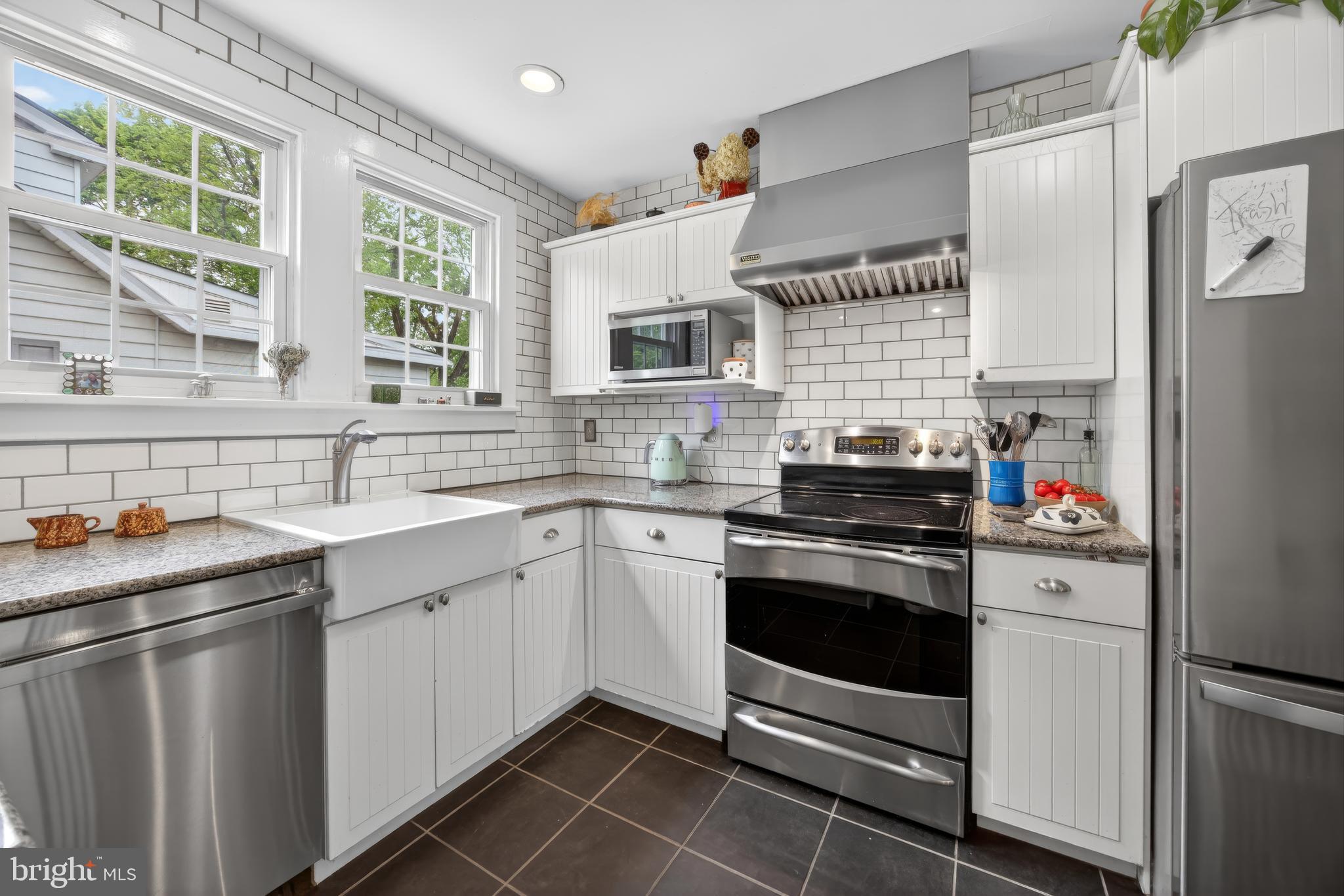 26 Mercer Avenue Doylestown, PA 18901 - Photo 10 of 24 a kitchen with stainless steel appliances a stove sink and microwave