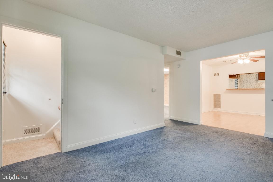 Living room facing dining and hallway