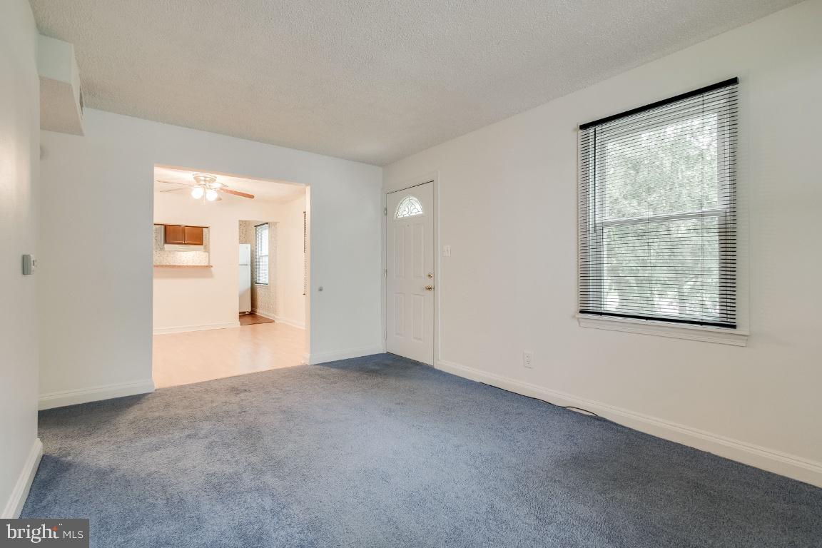 Living room facing dining and front door