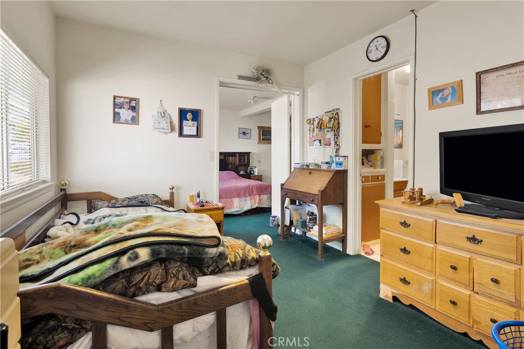 5335 Palmdale Road Phelan, CA 92371 - Photo 13 of 37 a bedroom with furniture and a flat screen tv