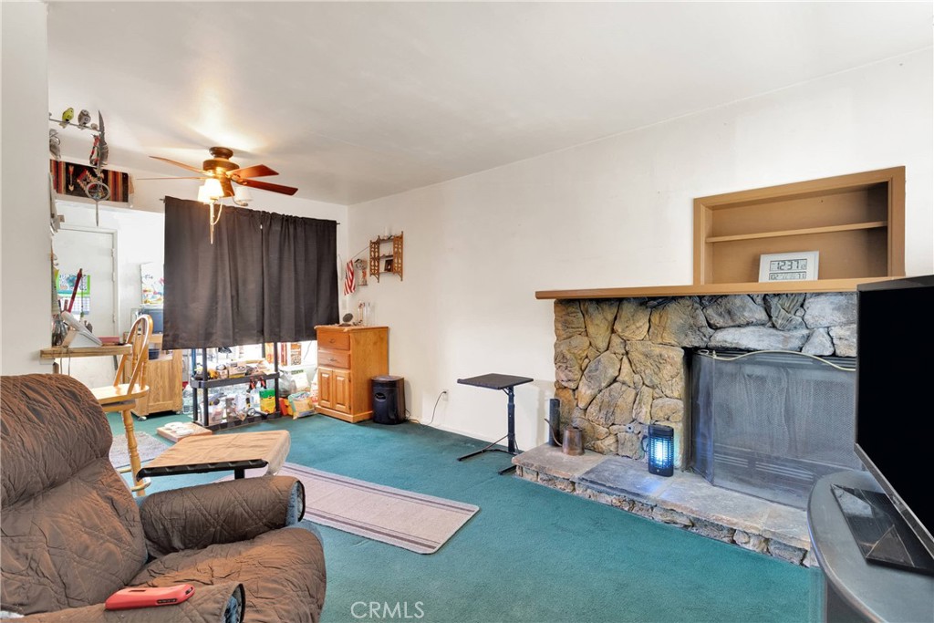 5335 Palmdale Road Phelan, CA 92371 - Photo 4 of 37 a living room with furniture and a flat screen tv