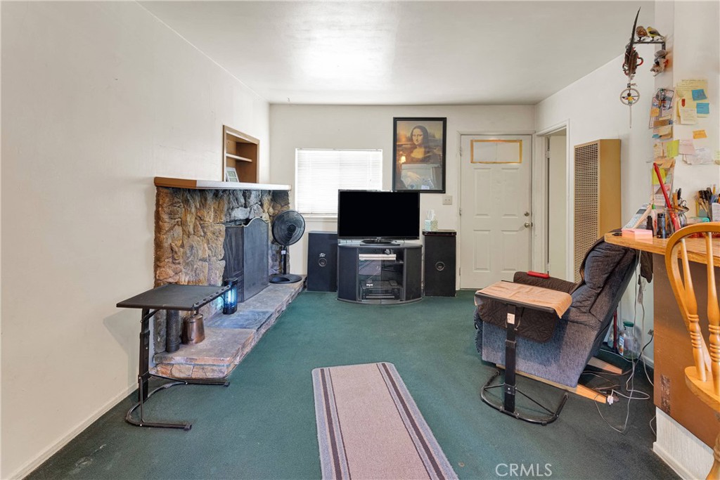 5335 Palmdale Road Phelan, CA 92371 - Photo 5 of 37 a view of a livingroom with furniture and a flat screen tv
