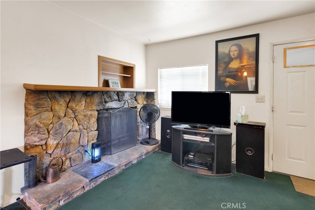 5335 Palmdale Road Phelan, CA 92371 - Photo 6 of 37 a living room with furniture and a flat screen tv
