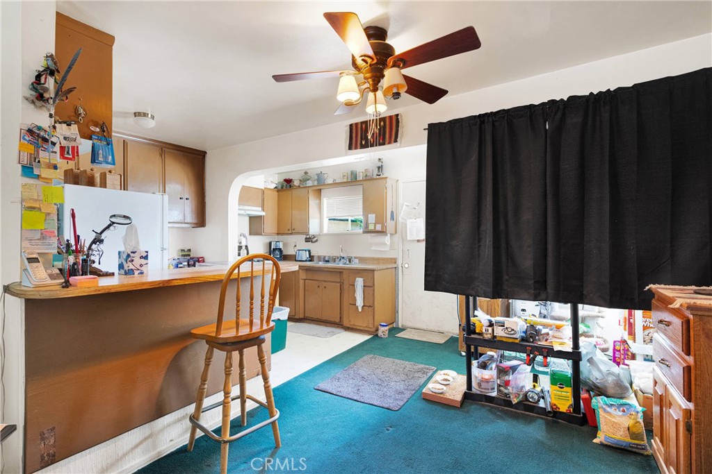 5335 Palmdale Road Phelan, CA 92371 - Photo 8 of 37 a garage with a table chairs and a stove