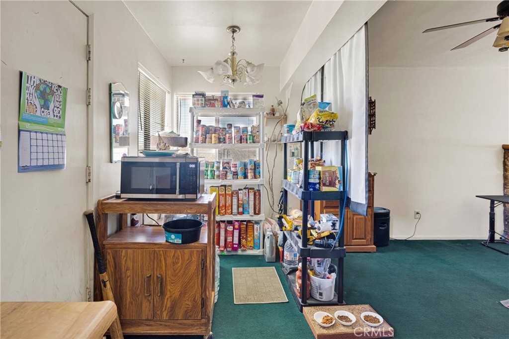 5335 Palmdale Road Phelan, CA 92371 - Photo 9 of 37 a living room with furniture and a book shelf
