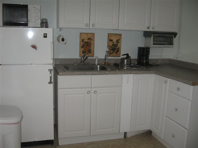 126 Lower County Road, Unit 6 Dennis Port, MA 02639 - Photo 4 of 12 a kitchen with stainless steel appliances white cabinets and a sink
