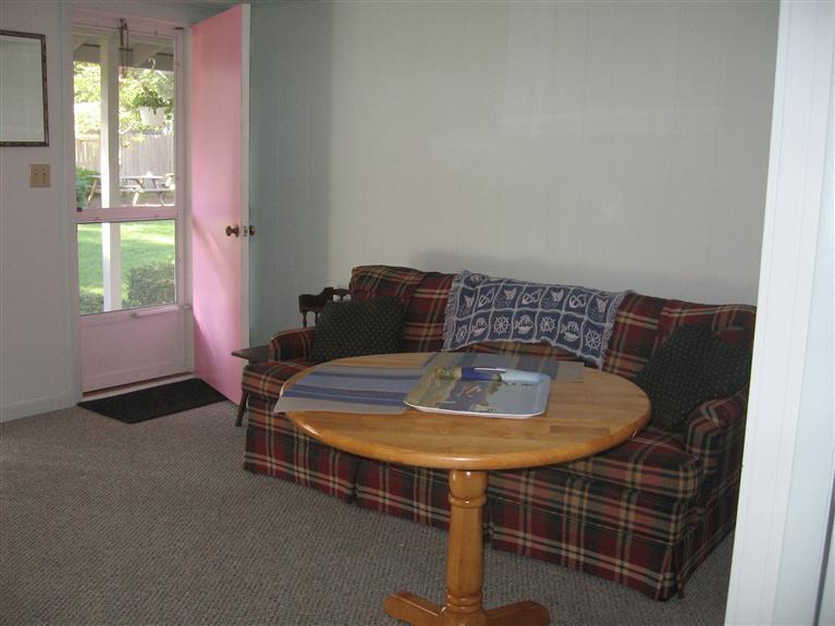 126 Lower County Road, Unit 6 Dennis Port, MA 02639 - Photo 7 of 12 a living room with furniture and a window