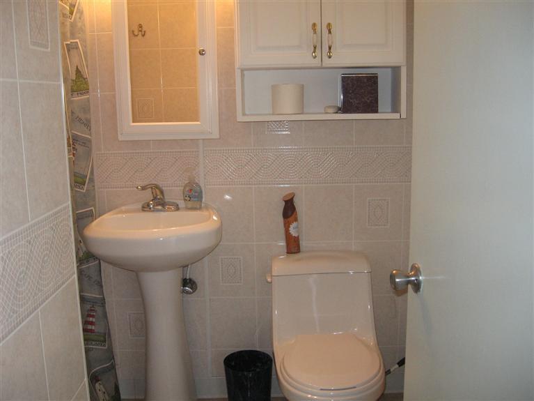 126 Lower County Road, Unit 6 Dennis Port, MA 02639 - Photo 8 of 12 a bathroom with a sink toilet and mirror