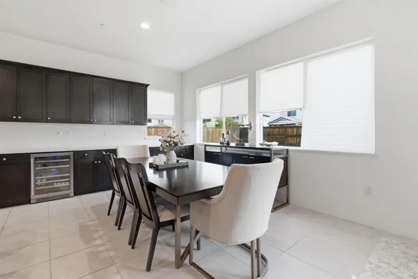 a large kitchen with a table and chairs