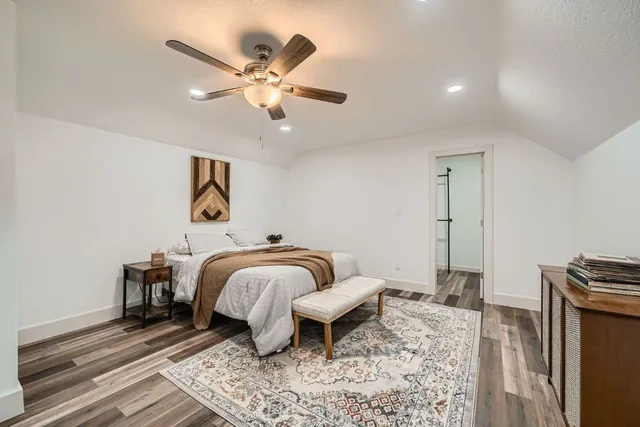 a bedroom with a bed and wooden floor