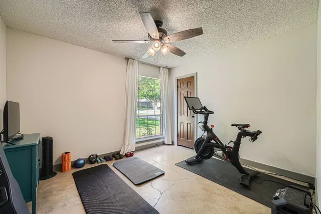 a room with gym equipment and a window